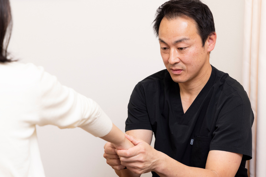 ばね指の症状や身体の状態に合わせて施術している様子